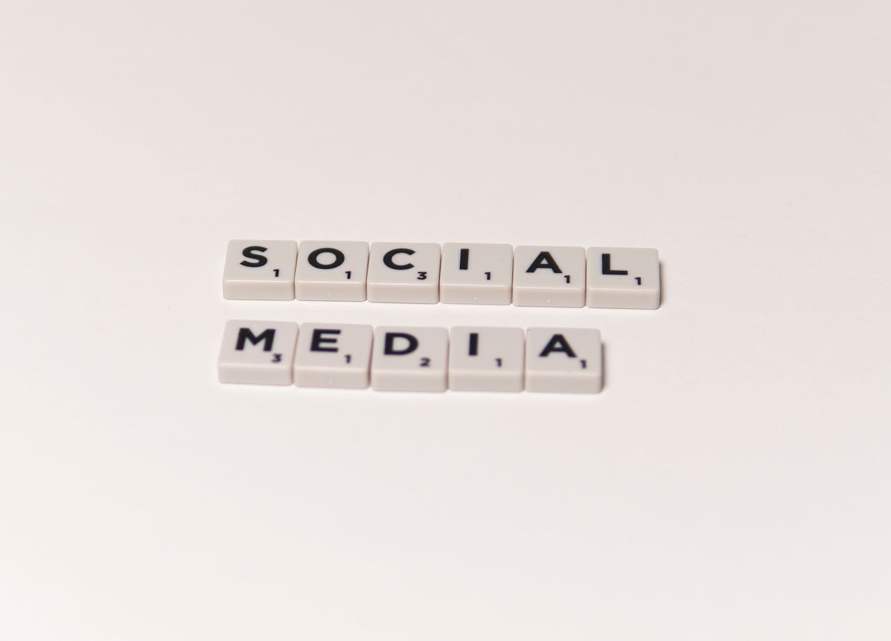 Scrabble tiles spelling social media on a white background, representing digital communication concepts.